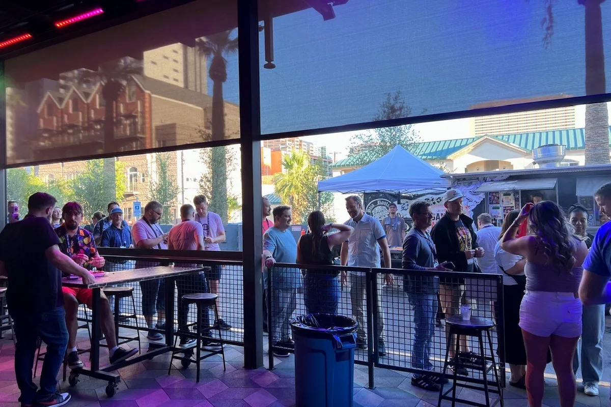 WordCamp US attendees gathering inside and outside Cobra Arcade Bar before the Beaver Builder after-party.