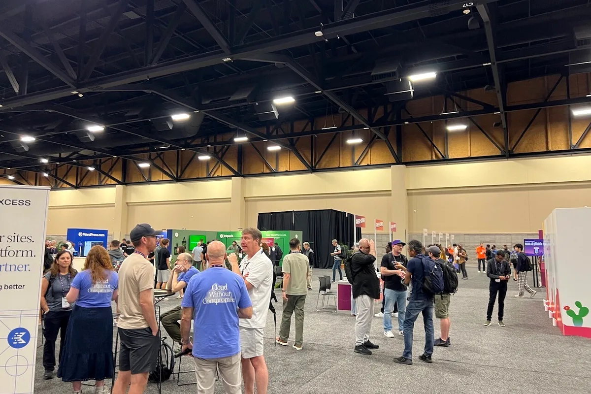A wide view of attendees and booths in the WordCamp US 2026 sponsor hall.