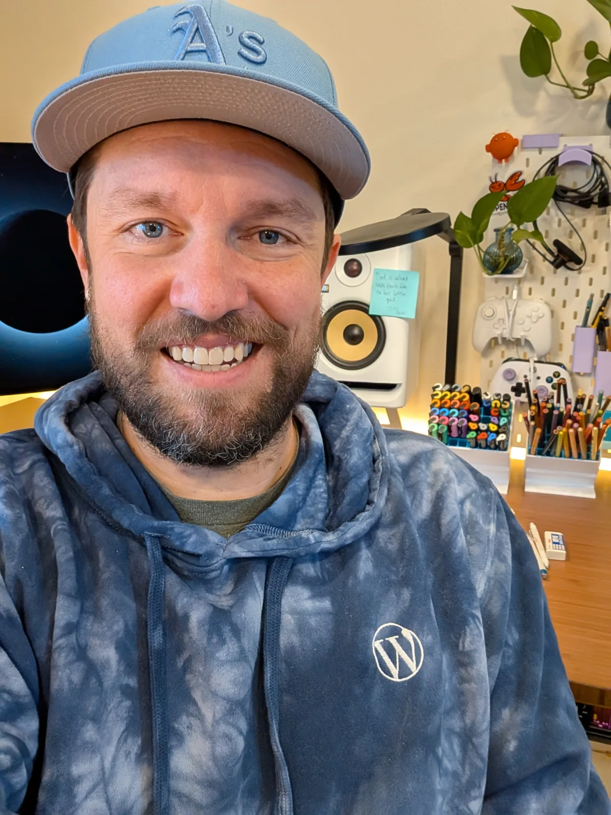 Robby smiling in a blue tie-dye WordPress hoodie.
